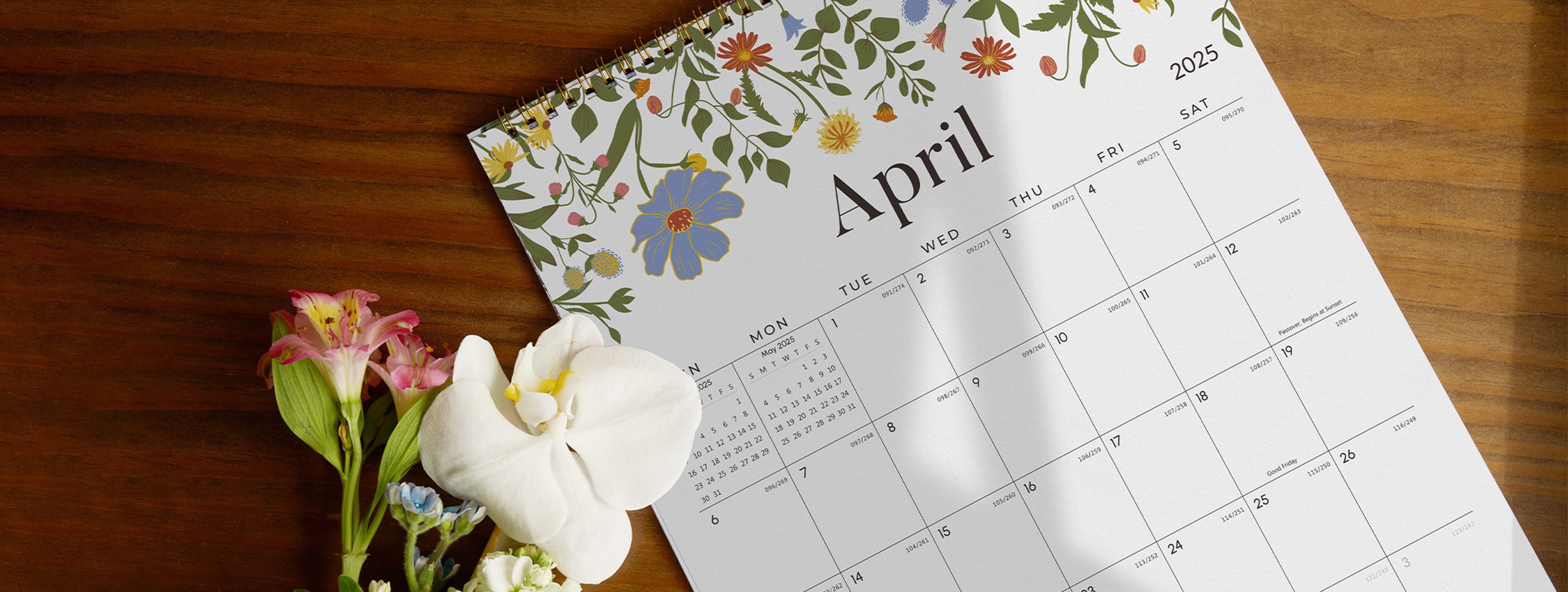 Calendar for April with floral design on a wooden surface